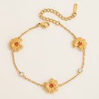 Seraphina Treasures gold bracelet with orange cubic zirconia daisy charms and clear crystal accents.