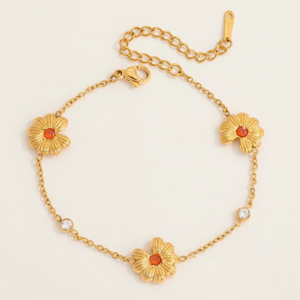 Seraphina Treasures gold bracelet with orange cubic zirconia daisy charms and clear crystal accents.