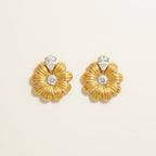 Seraphina Treasures gold daisy earrings with clear zircon center and pear drop accent.