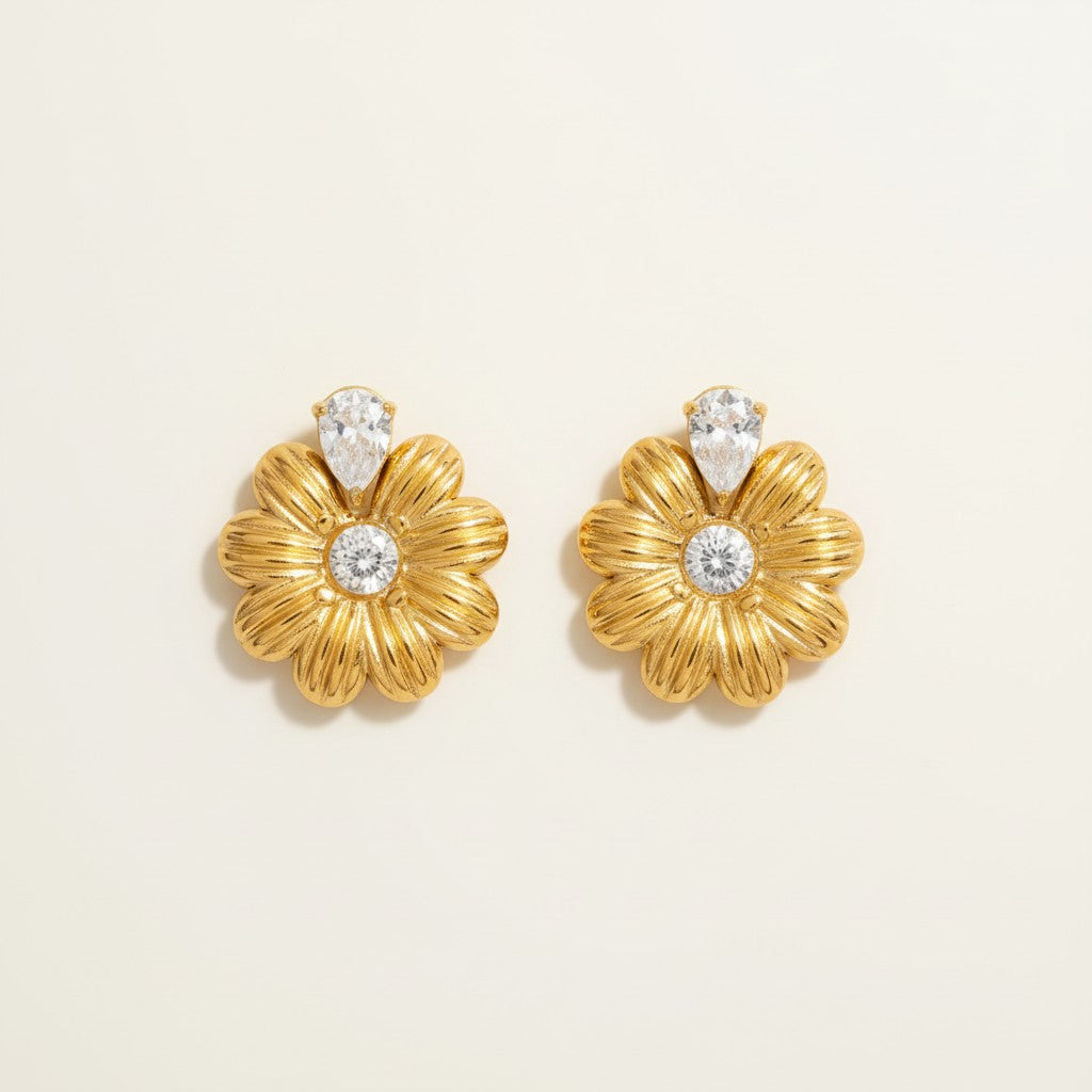 Seraphina Treasures gold daisy earrings with clear zircon center and pear drop accent.