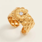 Seraphina Treasures gold-tone adjustable ring with quilted band and daisy design featuring a zircon center.