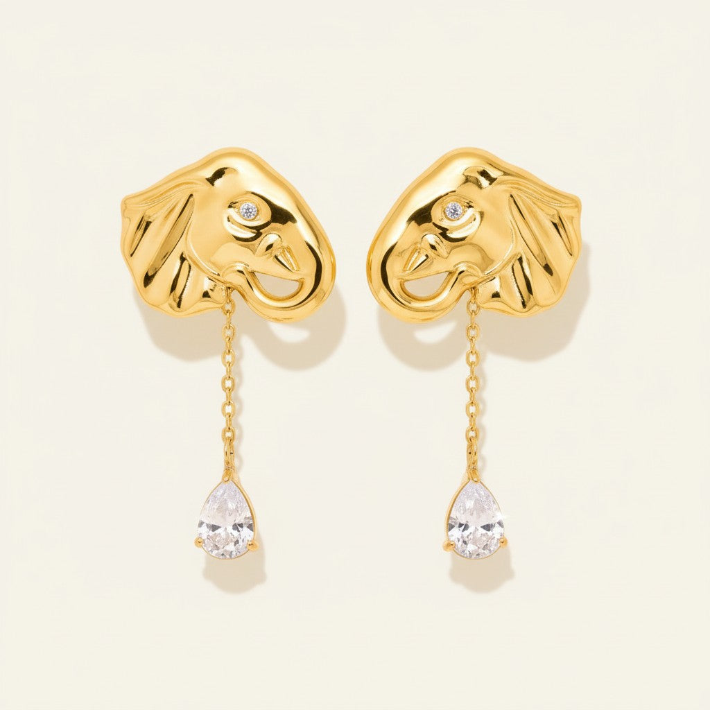 Seraphina Treasures gold elephant earrings with zircon drop, featuring intricate detail and a pear-shaped stone.