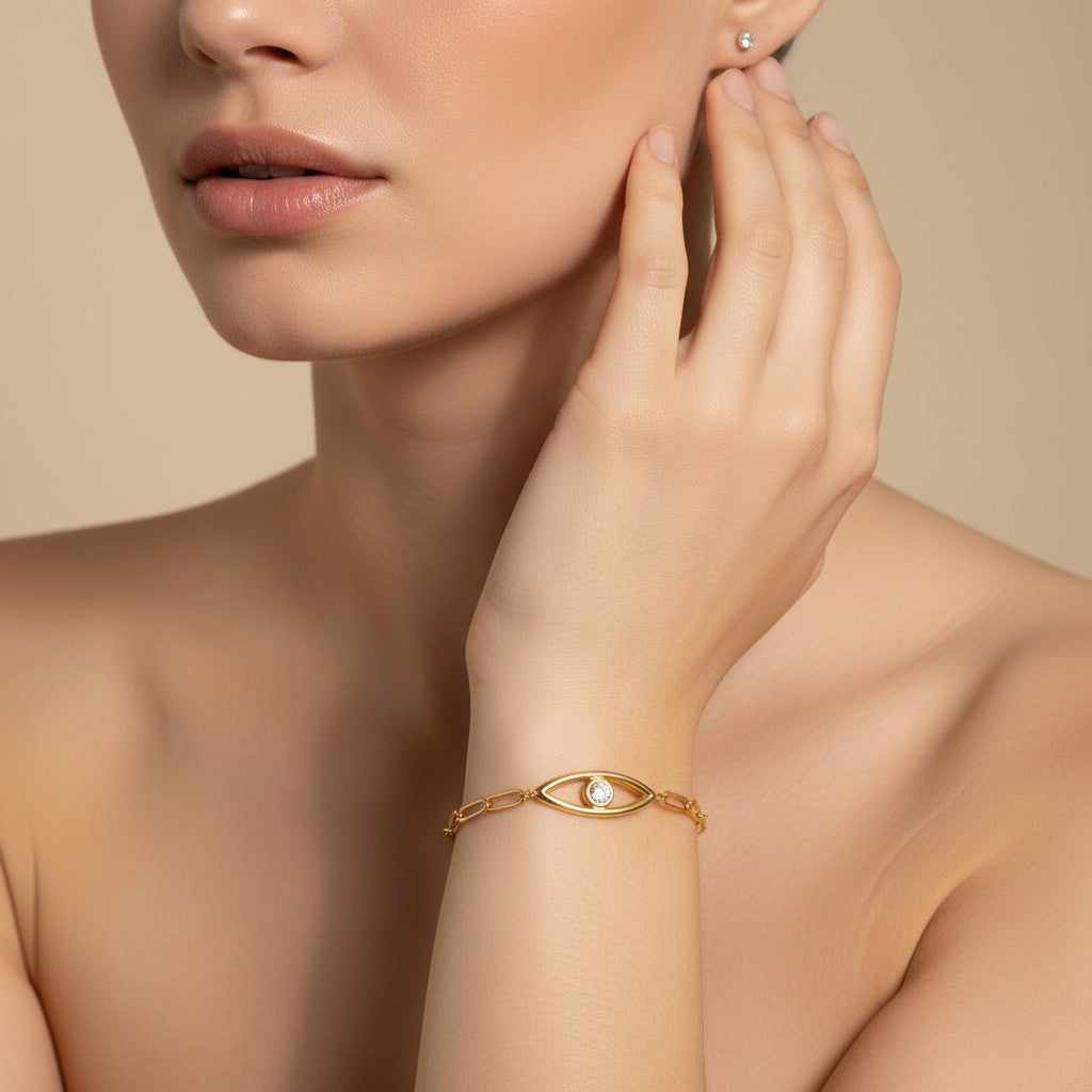 Seraphina Treasures gold-tone bracelet with paperclip chain and evil eye charm featuring a clear zircon.