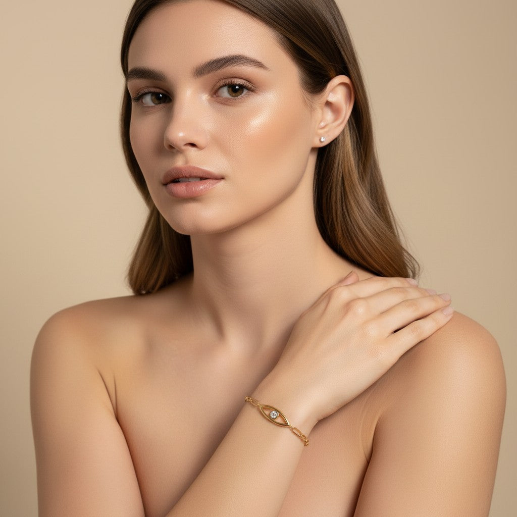 Seraphina Treasures Myrrha gold-tone bracelet with a clear zircon eye centerpiece, worn on a woman's wrist.