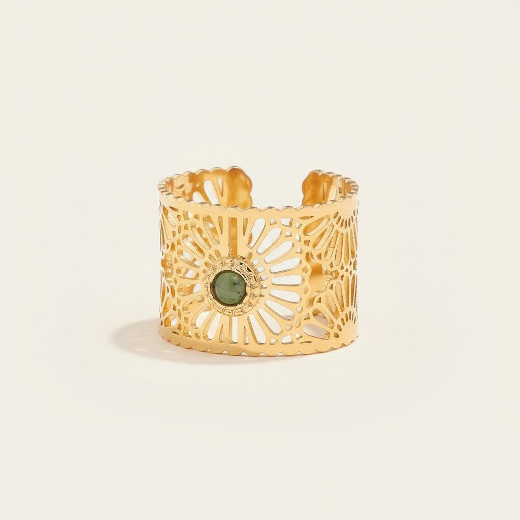 Seraphina Treasures gold-tone open ring with intricate filigree design and a central green stone. Adjustable.