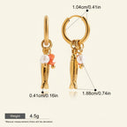 Seraphina Treasures gold fish hoop earrings with pearls and orange beads. Lightweight and hypoallergenic.