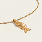 Seraphina Treasures Morwenna gold fish skeleton necklace with a delicate chain. Unique statement jewelry.