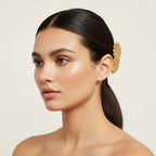 Seraphina Treasures gold floral barrette with three daisy-shaped charms and glossy finish.