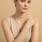 Seraphina Treasures gold necklace and bracelet set with floral charms and mother-of-pearl inlay.