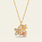 Seraphina Treasures gold necklace with crystal-embellished flowers and a pink ladybug charm.