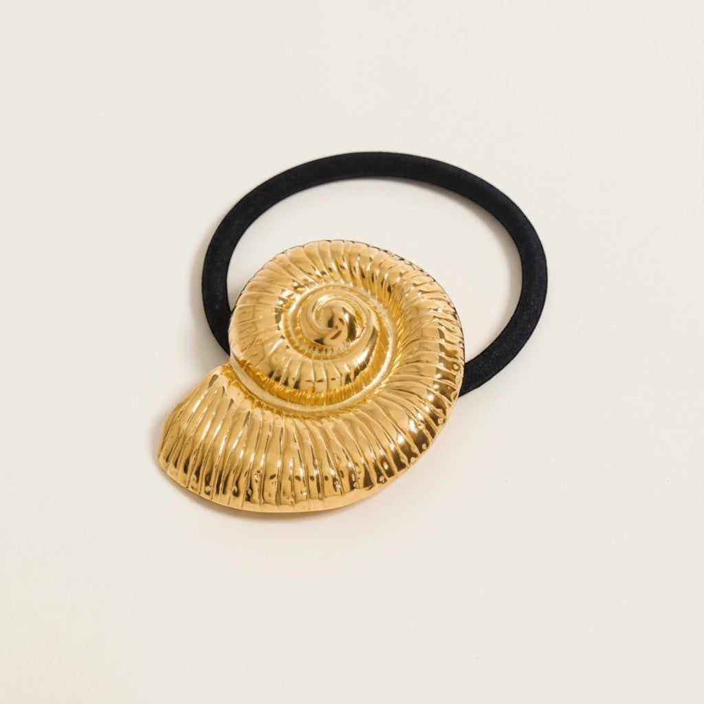 Seraphina Treasures gold fossil shell hair tie with black elastic band.