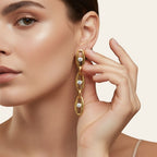 Seraphina Treasures gold-tone drop earrings with clear gemstones set in oval links.