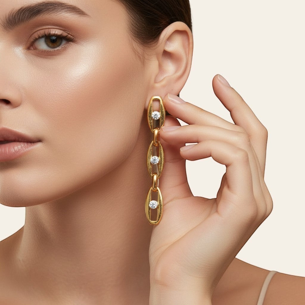 Seraphina Treasures gold-tone drop earrings with clear gemstones set in oval links.
