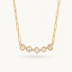 Seraphina Treasures gold necklace with five geometric cut clear zircon stones in round, square, and rectangular shapes.