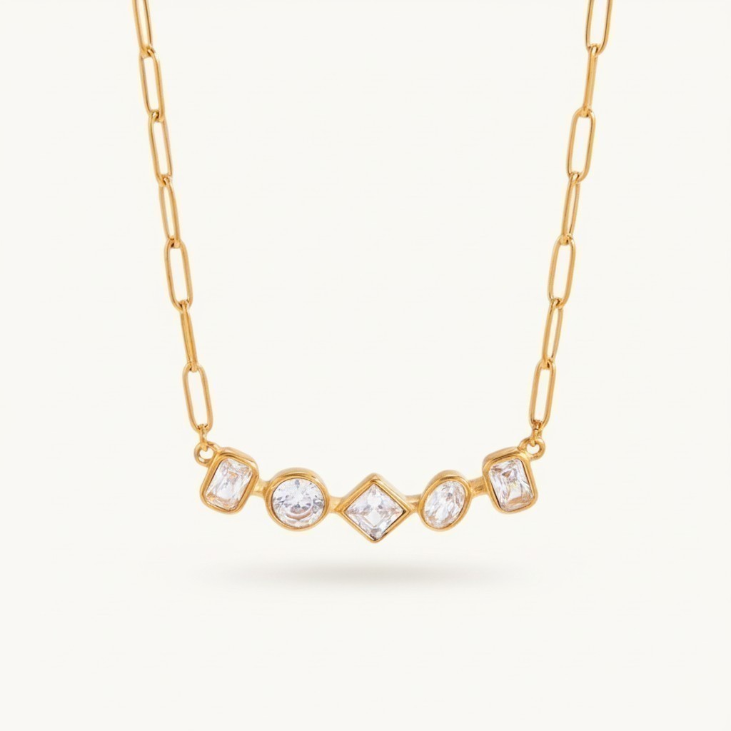 Seraphina Treasures gold necklace with five geometric cut clear zircon stones in round, square, and rectangular shapes.