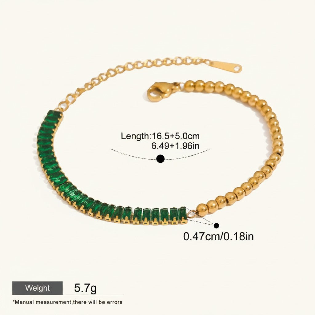Seraphina Treasures gold bracelet with a half chain of small gold beads and a half chain of baguette-cut green zirconia stones.