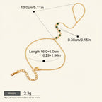 Seraphina Treasures Hecate bracelet with green zircon accents, gold-tone chain, and adjustable clasp. Connects wrist to finger.