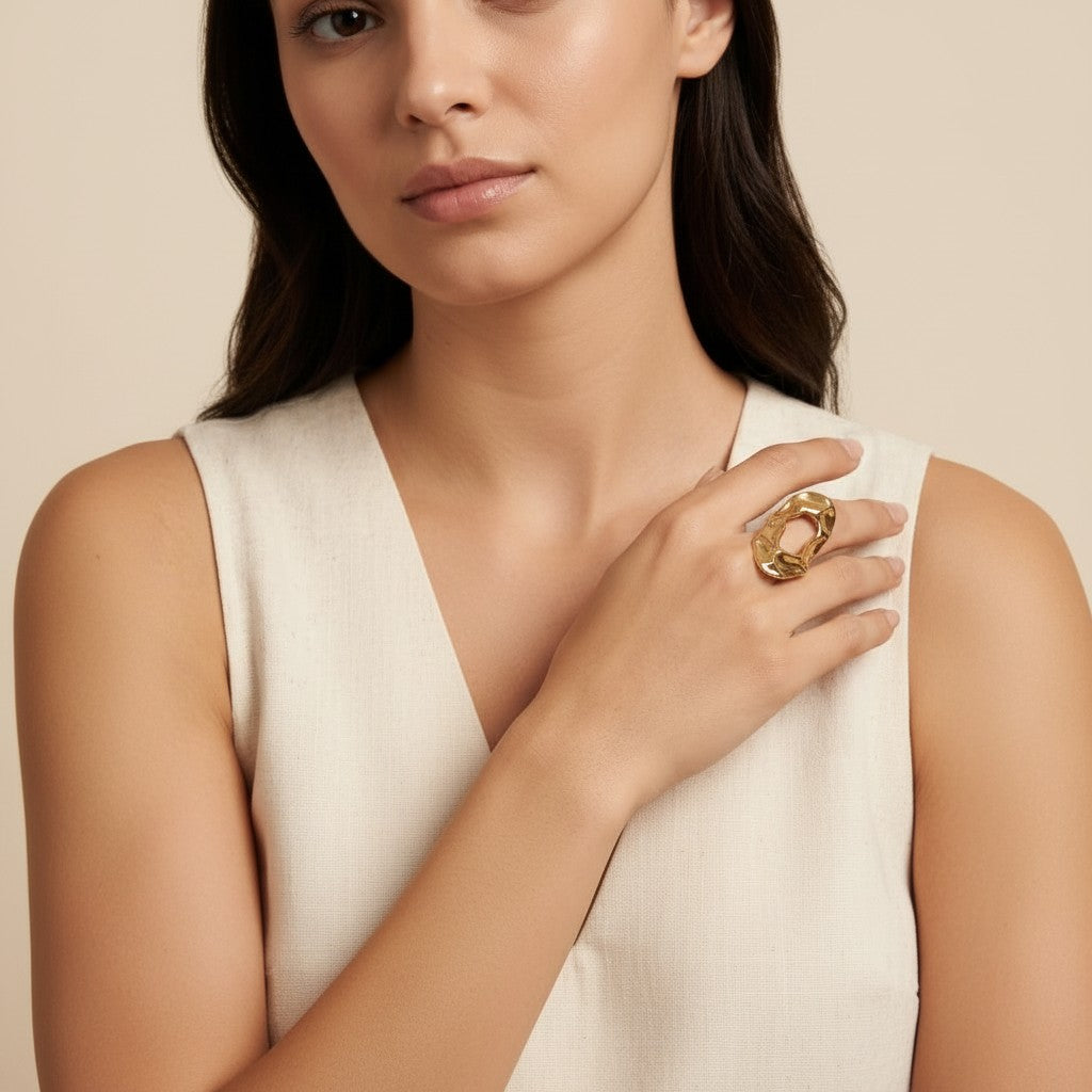 Seraphina Treasures gold hammered abstract open ring on a woman's hand.