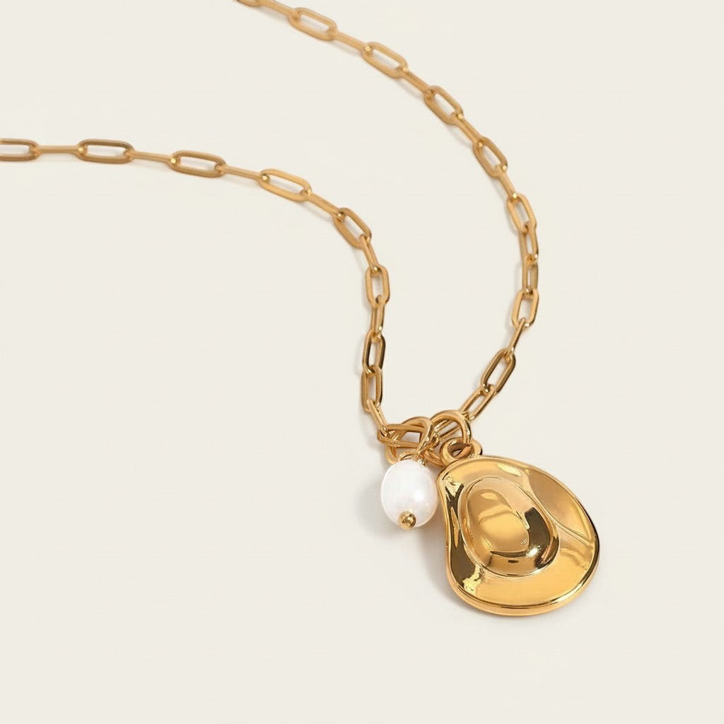 Seraphina Treasures gold necklace with a hat-shaped pendant and freshwater pearl accent.