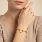 Seraphina Treasures gold-tone stainless steel bracelet with a crystal-encrusted heart pendant and chunky oval links.