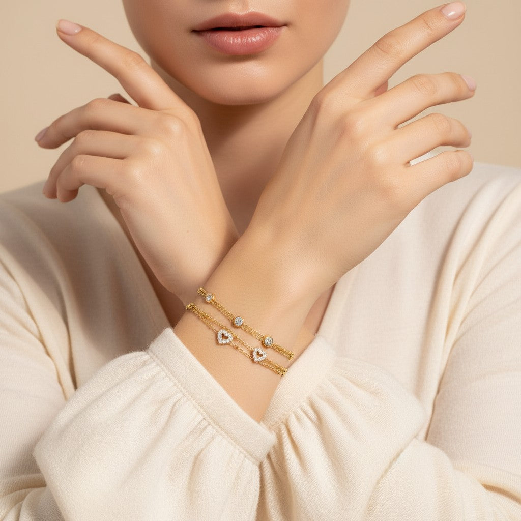 Seraphina Treasures gold-tone two-tier bracelet with beaded chains, cubic zirconia accents, and heart charms.