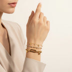 Seraphina Treasures gold-tone bracelets with heart charms and cubic zirconia stones. One bracelet features a chunky chain with a heart charm, another a delicate chain with cubic zirconia.