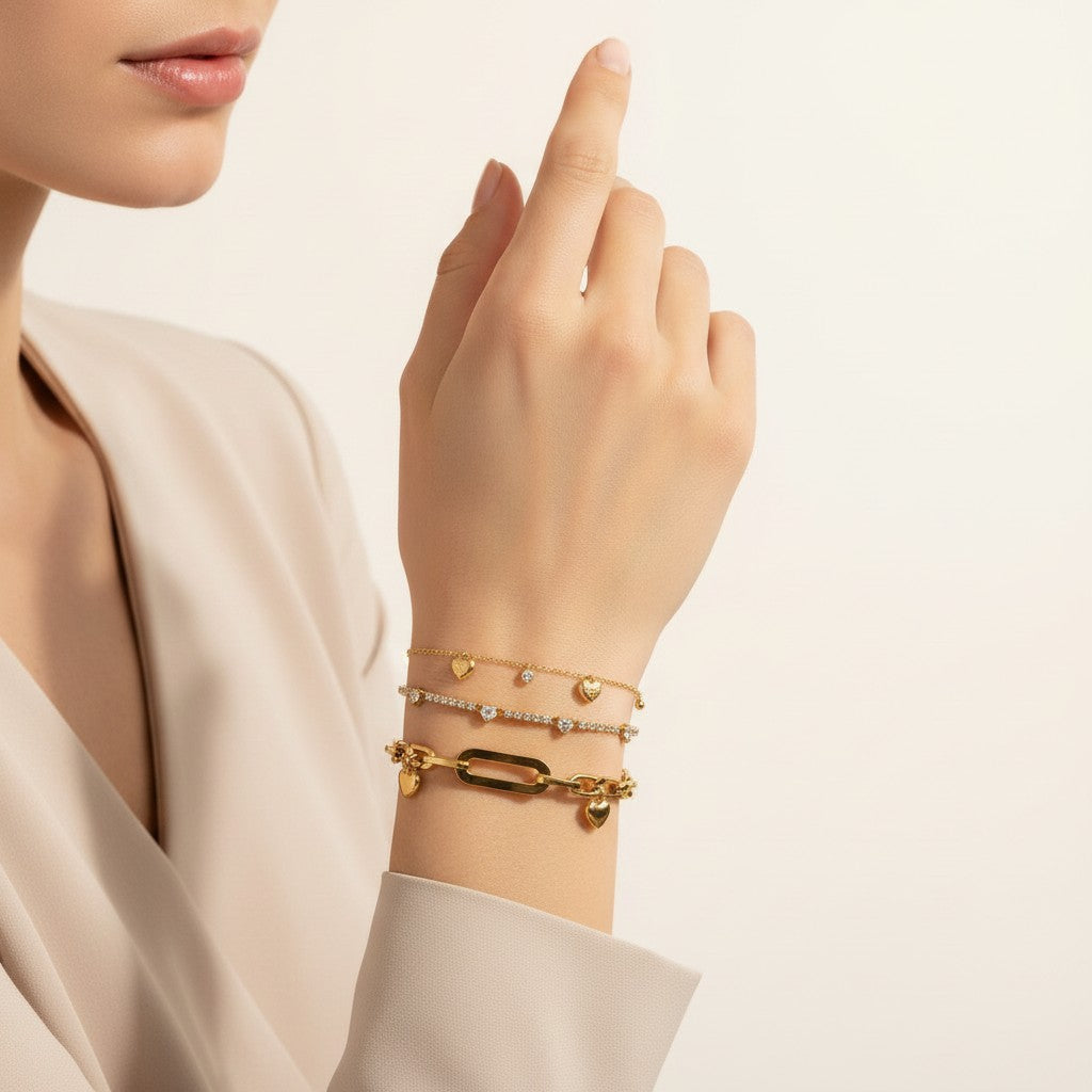 Seraphina Treasures gold-tone bracelets with heart charms and cubic zirconia stones. One bracelet features a chunky chain with a heart charm, another a delicate chain with cubic zirconia.
