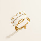 Seraphina Treasures gold-tone bracelet with heart charms and clear zirconia stones. Delicate chain with link design.