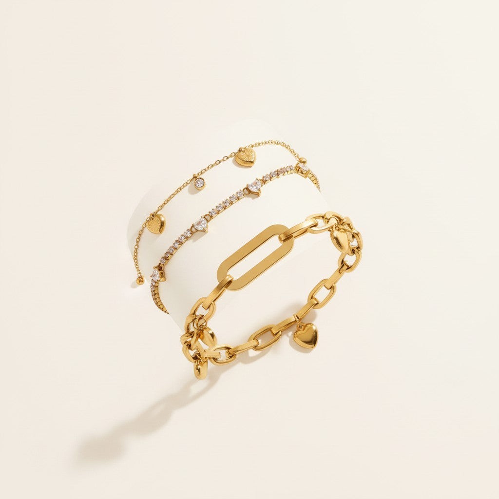 Seraphina Treasures gold-tone bracelet with heart charms and clear zirconia stones. Delicate chain with link design.
