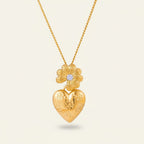 Seraphina Treasures gold necklace with a daisy charm and a heart pendant engraved with floral details and a small clear gem.