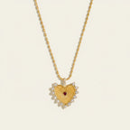 Seraphina Treasures gold heart necklace with red center stone and clear zirconia accents.