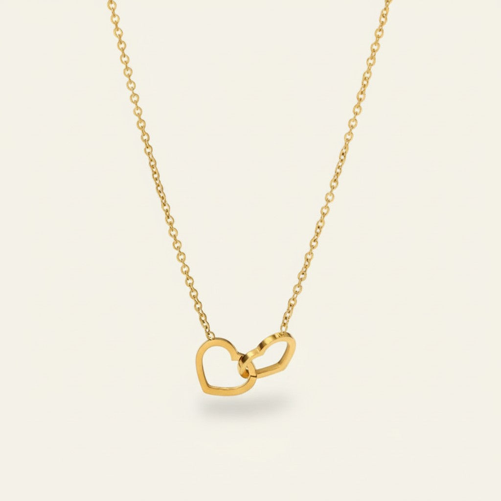 Seraphina Treasures gold-tone necklace with two intertwined hollow hearts, symbolizing connection and affection.
