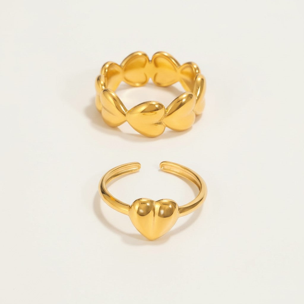 Seraphina Treasures gold open-band rings, one with a heart motif, the other with linked heart shapes.