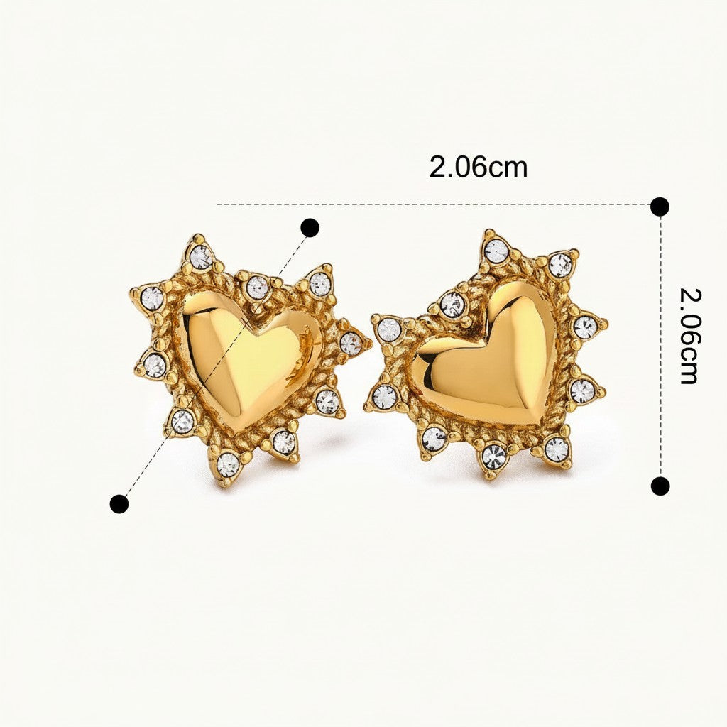 Seraphina Treasures gold heart stud earrings with clear crystal accents, featuring a sunburst-like border.