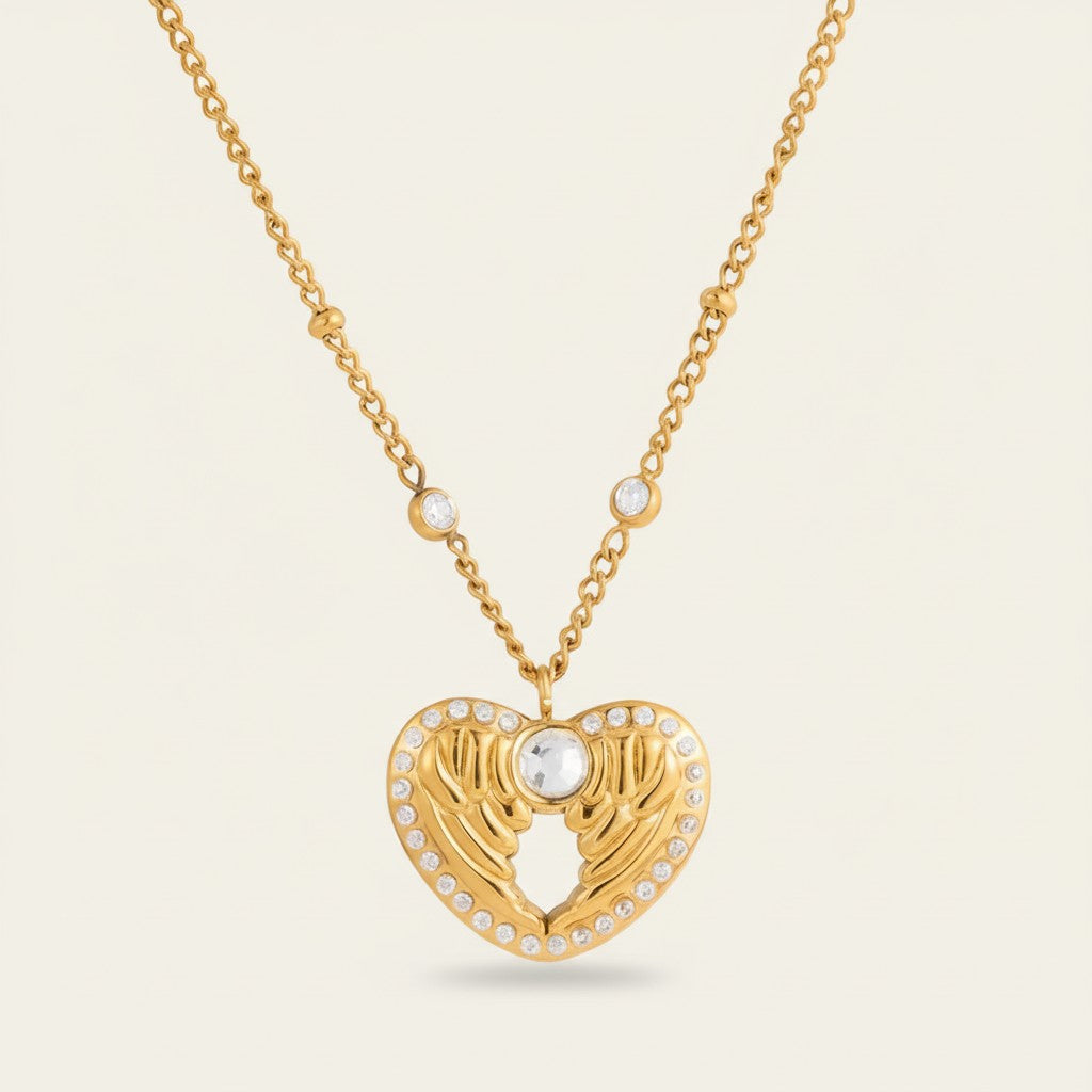 Seraphina Treasures gold heart necklace with wing details and clear zircon stones. A symbol of love and freedom.