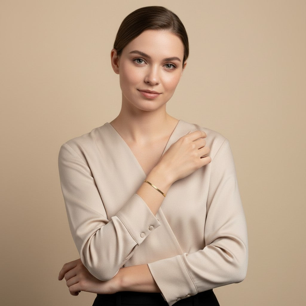 Seraphina Treasures gold herringbone chain bracelet on a woman's wrist, perfect for layering.