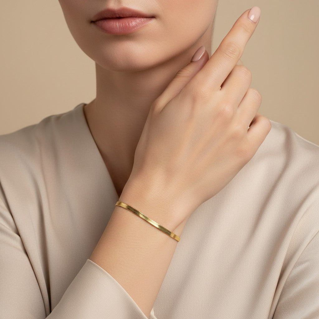 Seraphina Treasures gold herringbone chain bracelet with adjustable clasp and "K18" charm.