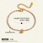 Seraphina Treasures gold-tone bracelet with clear zirconia stones and a gold initial 'J' pendant. Adjustable length.
