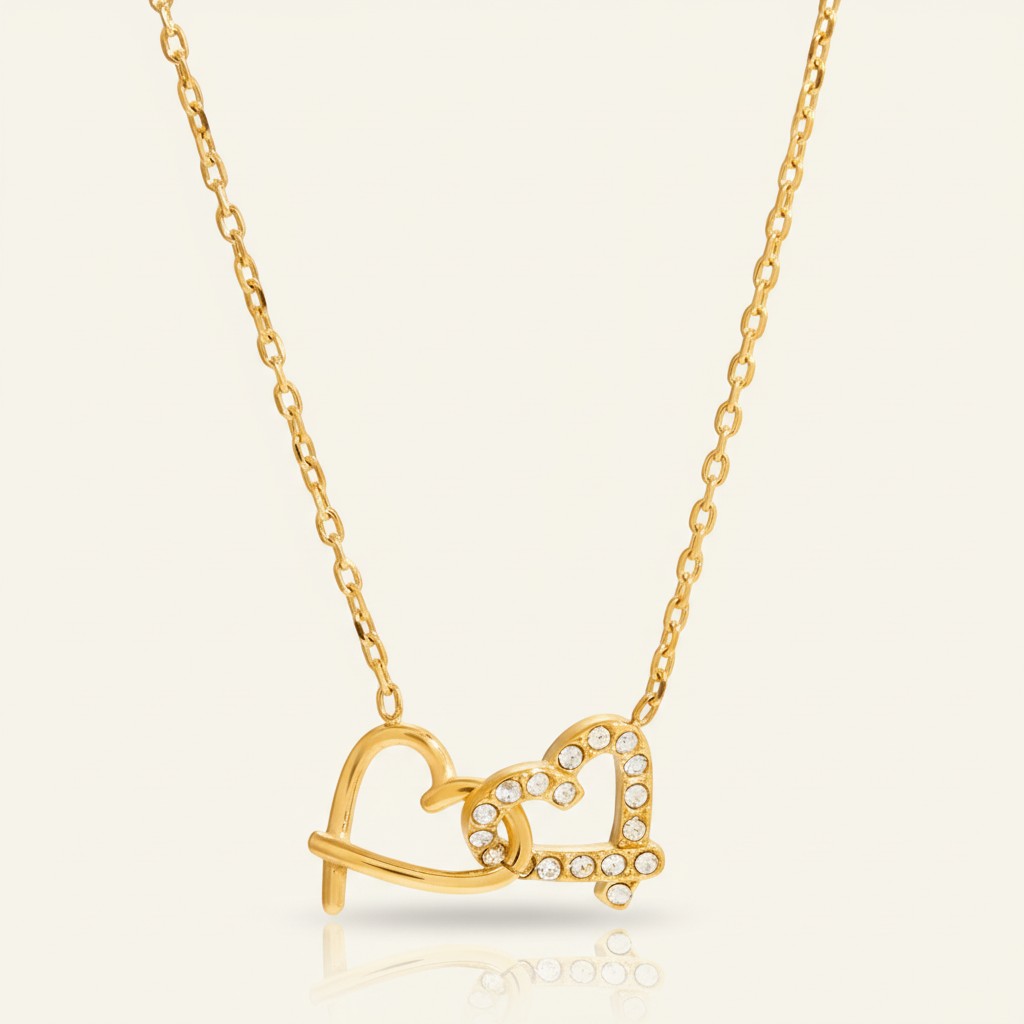 Seraphina Treasures gold-tone necklace with two intertwined hearts, one plain and one paved with clear crystals.