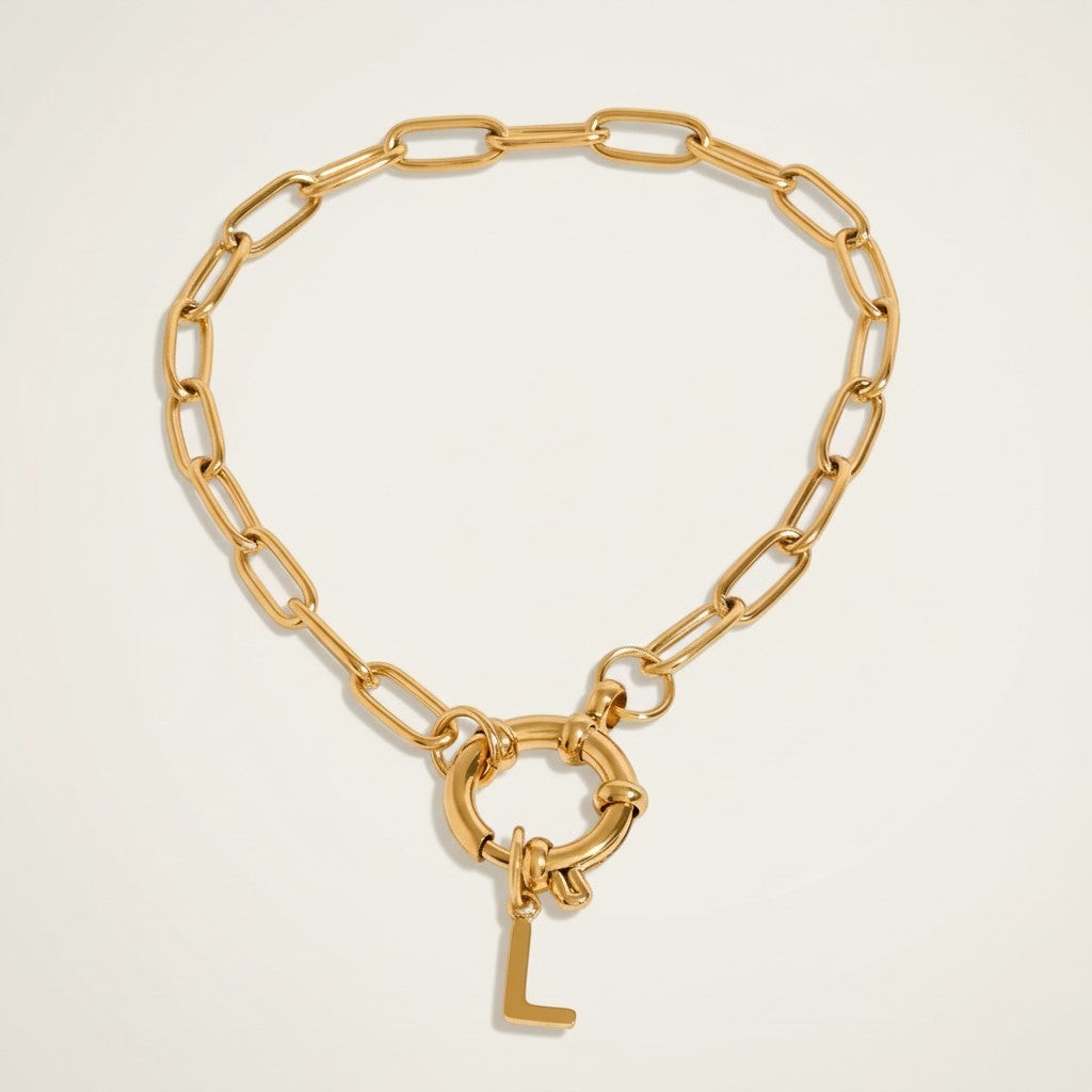 Seraphina Treasures gold chain bracelet with a large clasp and a dangling letter L charm.