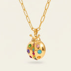 Seraphina Treasures gold ladybug necklace with colorful cubic zirconia stones on a link chain. Whimsical and sparkling.
