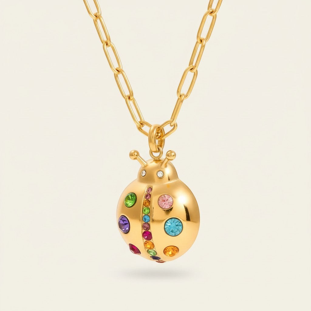 Seraphina Treasures gold ladybug necklace with colorful cubic zirconia stones on a link chain. Whimsical and sparkling.