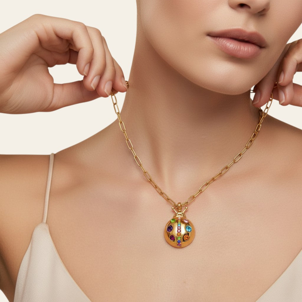Seraphina Treasures gold necklace with a ladybug pendant adorned with colorful cubic zirconia stones.