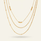 Seraphina Treasures gold layered necklace with delicate chains and small bead accents.