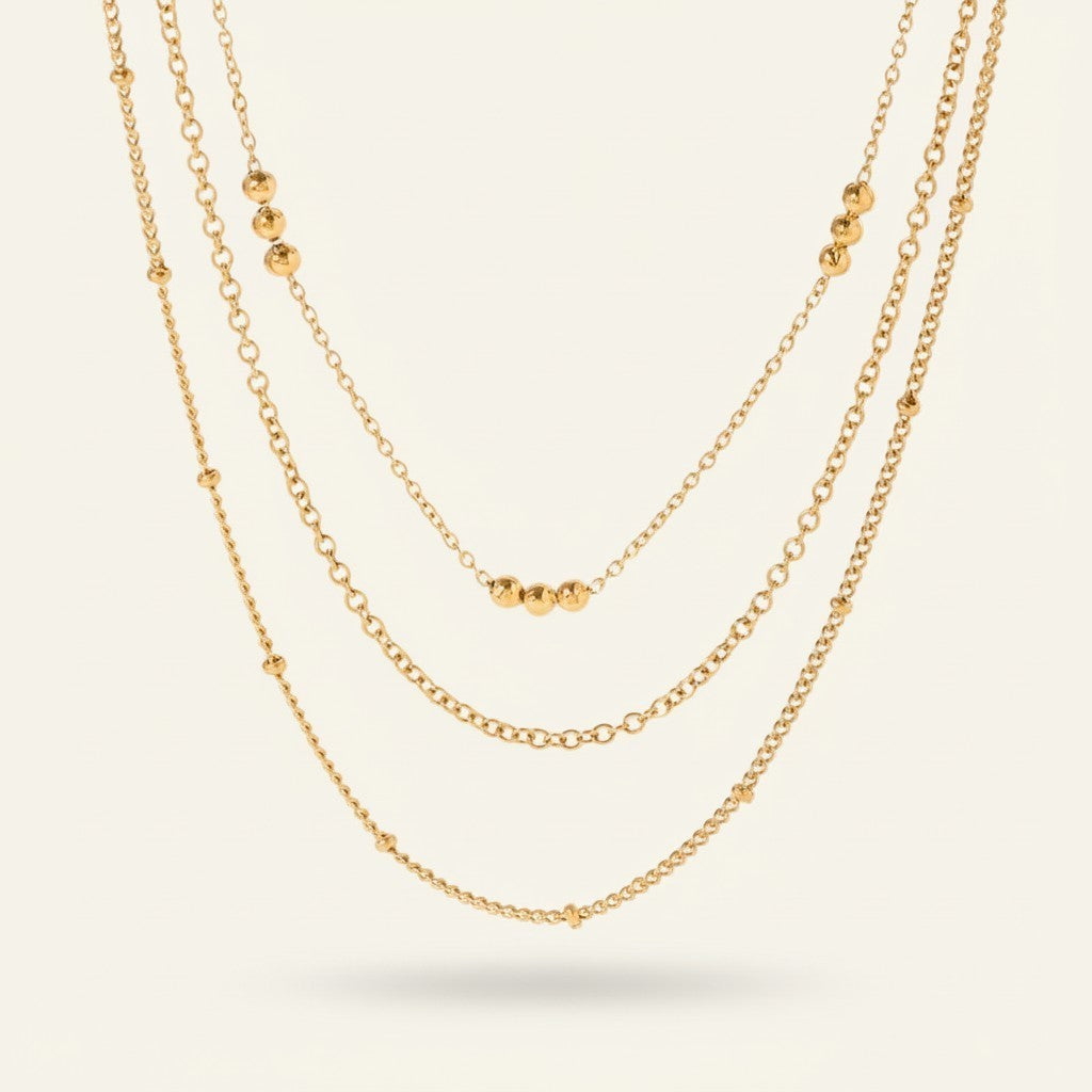 Seraphina Treasures gold layered necklace with delicate chains and small bead accents.