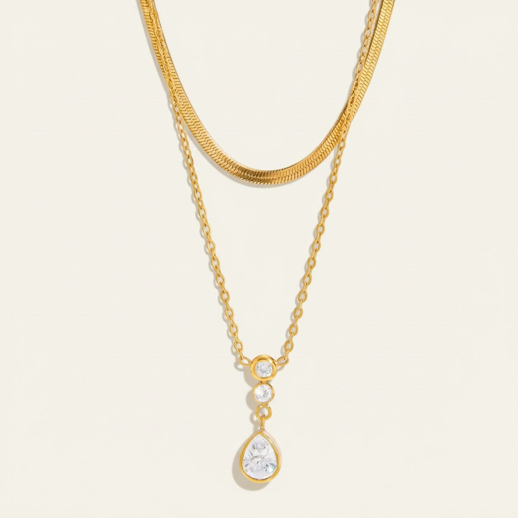Seraphina Treasures gold layered necklace with snake chain and teardrop pendant with cubic zirconia.