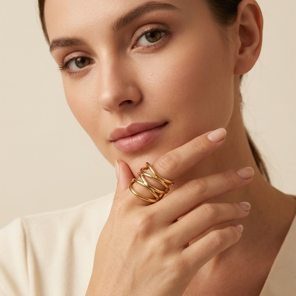 Seraphina Treasures gold-tone metal Drusilla ring with layered, abstract design on a model's finger.
