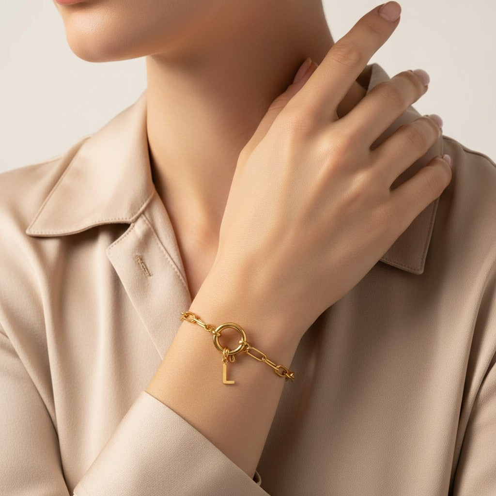 Seraphina Treasures gold-tone chain bracelet with a toggle clasp and a dangling letter L charm. Waterproof and hypoallergenic.