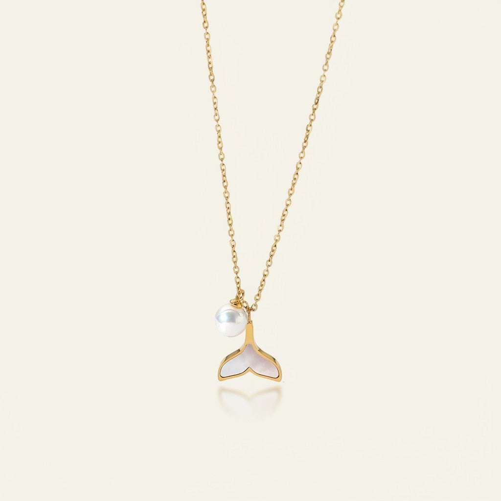 Seraphina Treasures gold necklace with a pearl and a white mermaid tail pendant.