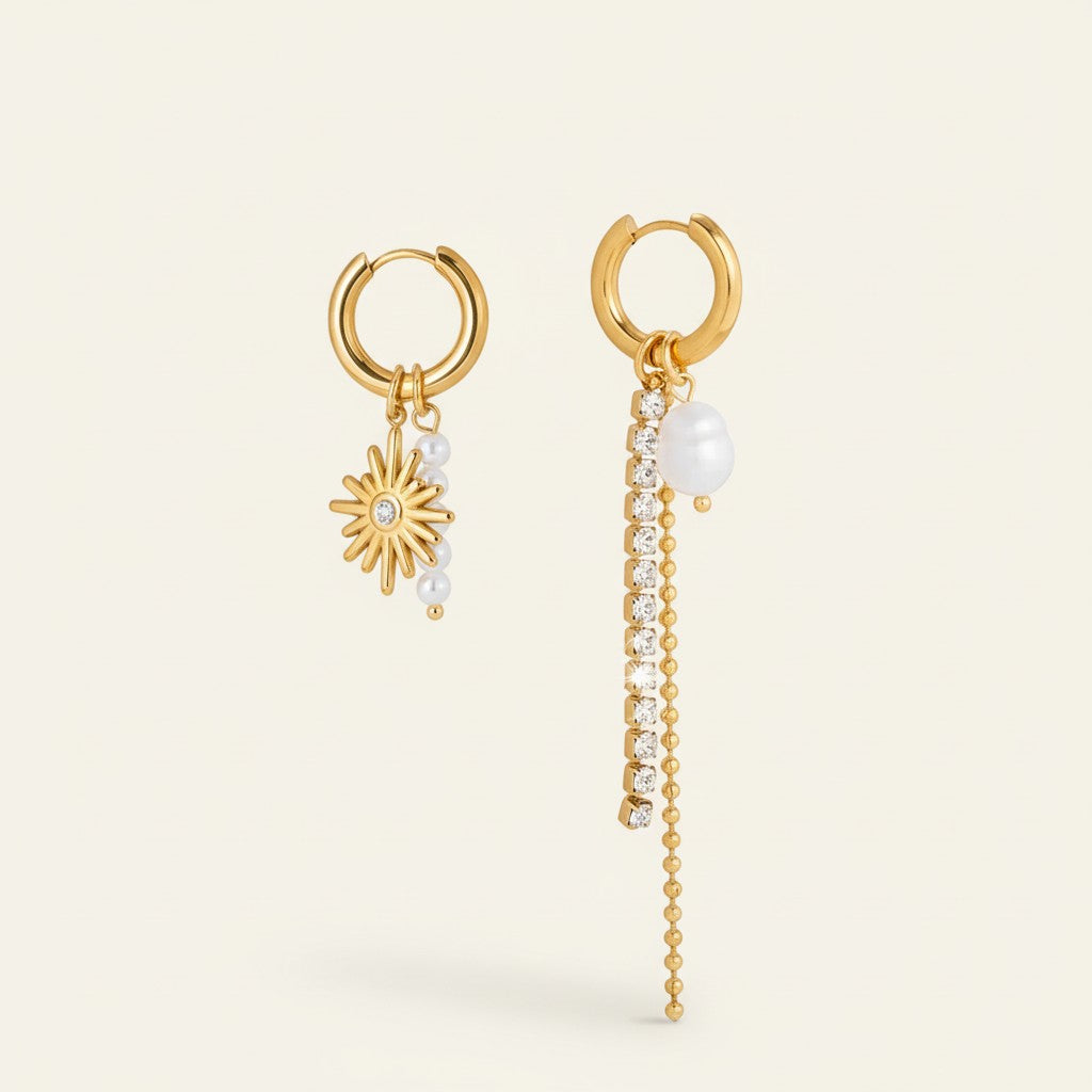 Seraphina Treasures gold-tone mismatched earrings with imitation pearls, crystals, and chain tassels.